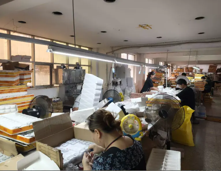 Team members manually handling and packing eyewear during order preparation